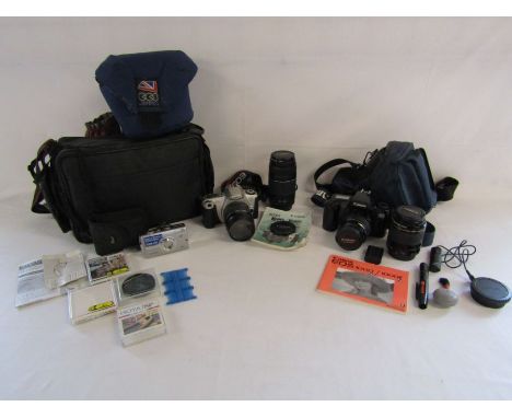 An Olympus SP-700 compact digital camera, Canon EOS 1000F film camera with case and Canon&nbsp; EOS 300 film camera with case