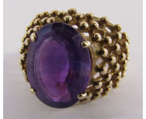 9ct gold ring with oval step cut amethyst approx. 6.5ct 4 claw setting, beaded design shoulders - total weight 8gm - ring siz