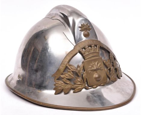 A good French Fireman’s plated Adrian style helmet, brass bound skull with “SAPEURS POMPIERS SEREMANGE” brass badge, leather 