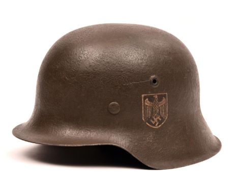 A Third Reich M42 single decal steel helmet, the skull with rough dark grey finish and eagle decal, with maker’s mark “NS” (V