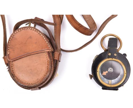A WWI prismatic marching compass, by E Koehn, Geneva, number 158015, marked with broad arrow and “1918”, the front marked “Ve
