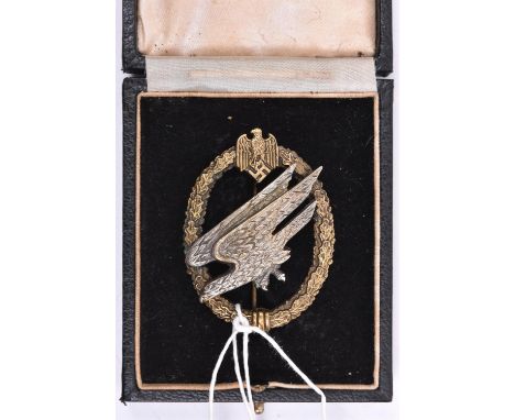 A Third Reich Army Parachutists breast badge, silvered eagle with gilt wreath, marked on reverse “C.E. JUNCKER BERLIN S.W”, i