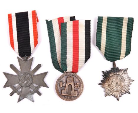 A Third Reich War Service cross with swords, an Eastern Peoples medal and a D.A.K medal, All with ribbons. GC (3)            