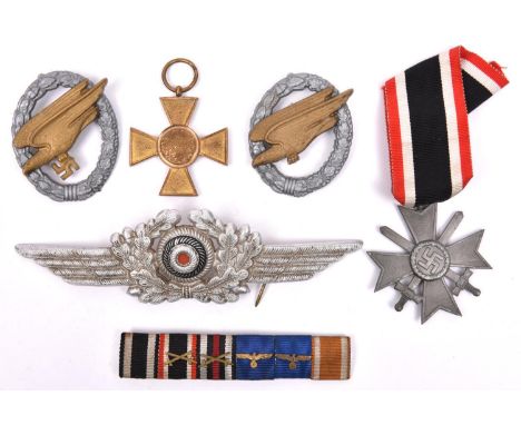 A Third Reich Luftwaffe NCO’s cap cockade (one pin missing); grey metal War Merit Cross 2nd class with swords and ribbon; 6 r