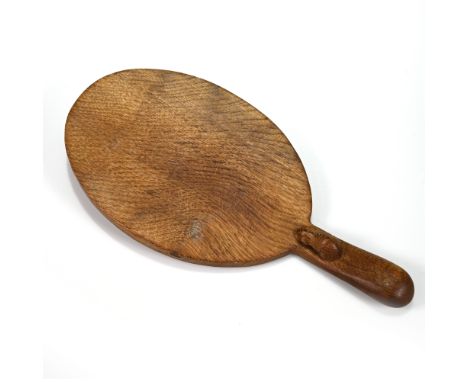 An oval carved oak cheese board with the Robert "Mouseman" Thompson mouse carved into the handle. 37cm x 18cm.