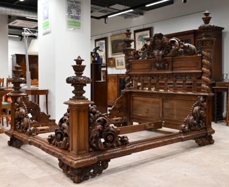 A very high quality mid 19th Century Italian King sized (plus) bed. Constructed in Walnut it is profusely carved throughout w