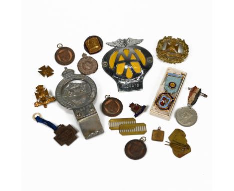 A collection of badges including: a South African AA badges; The Royal East African Automobile Association chromed badge stam