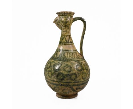 A Seljuk Kashan cockerel headed pottery ewer, decorated in geometric green glazes over a yellow ground. The squat spherical b