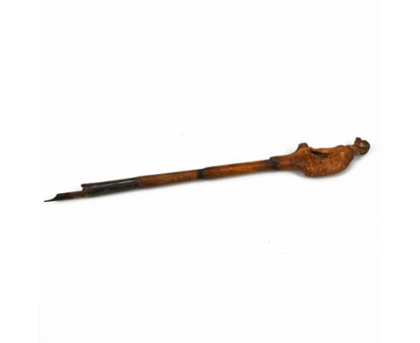 A 19th Century carved lime wood dip pen, the shaft carved in the form of bamboo, the finial as a seated hound. Probably Black