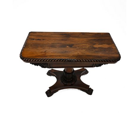 A William IV rosewood folding card table with carved scrolled edge with acanthus leaf details to the rounded corners, opening