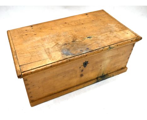 A large sized 19th Century stripped pine trunk with iron handles and hinges. Opens to reveal large open storage space and sma