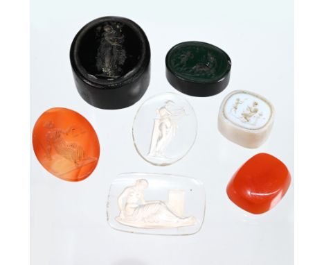 A small collection of Intaglios comprising a dark red oval, depicting a Greco-Roman lady at a tree; an orange oval stone depi