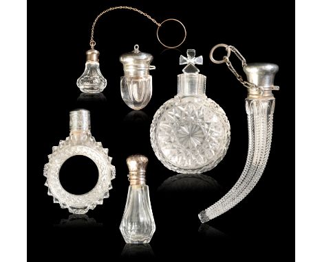 A GROUP OF SIX SCENT BOTTLES comprising: A French crystal miniature scent bottle, of decanter form, the cork-lined silver-gil