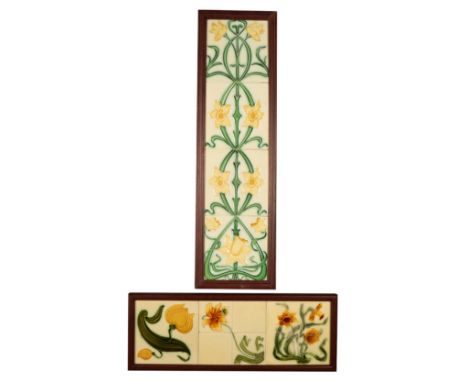 A FRAMED SET OF THREE PARTIAL RELIEF ART NOUVEAU FLORAL TILES c. 1905, in complimentary ochre and olive-green tones on cream 