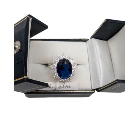 Silver blue stone and cubic zirconia oval cluster ring, stamped 925, boxed Condition Report:Size Q/R, head L = 2cm