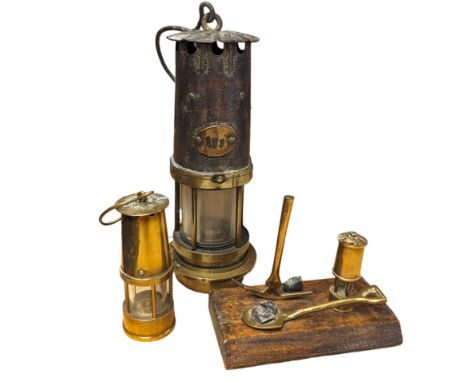 Miners lamp, with plaque numbered 173, together with a miniature brass miners lamp and a wooden paperweight with applied bras
