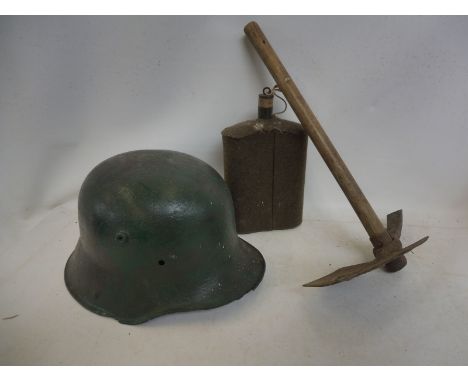 A military helmet, a trench axe and a flask.