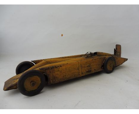 An early tinplate clockwork model of the Golden Arrow Landspeed Record holding car with detached fin tail.