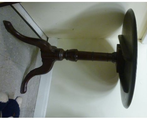 A George III mahogany pedestal table, having a baluster turned column, on a splayed tripod base  29''h  25''dia       SR