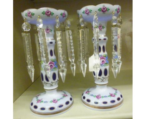 A pair of 20thC Continental lustre vases, decorated in floral painted white enamel, on blue, highlighted with gilding, suspen