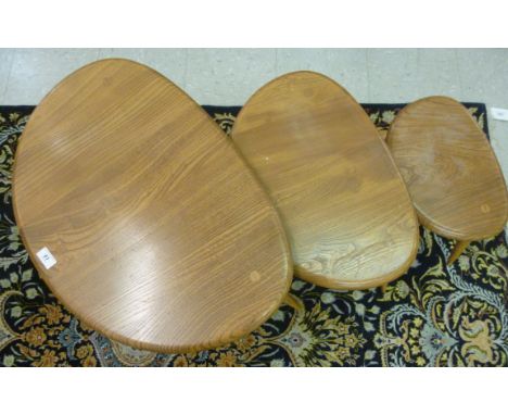 A nesting set of  three Ercol light coloured elm and beech pebble top occasional tables  largest 15''h  25.5''w       SR
