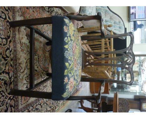 A late 18thC Chippendale design, mahogany framed elbow chair, having a foliate carved and scrolled crest, over a pierced ribb