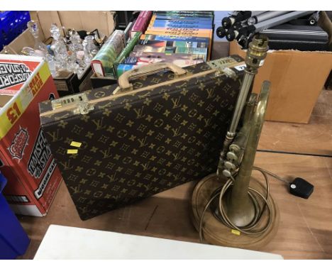 A briefcase and a trumpet lamp