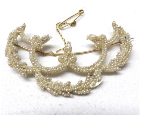 A Mother-of-Pearl and Seed Pearl mounted Swag Brooch, minor losses, 7cm wide  