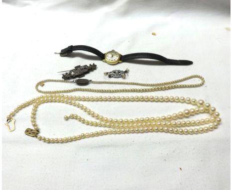 A Mixed Lot including: a Cultured Pearl Double Strand Necklace with yellow metal clasp, stamped "9ct" (partially unstrung); a
