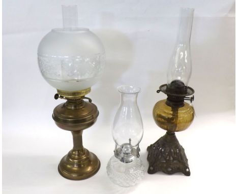 Mixed lot: Victorian Oil Lamp with amber glass font and pierced cast base together with a 20th Century Brass based Oil Lamp a