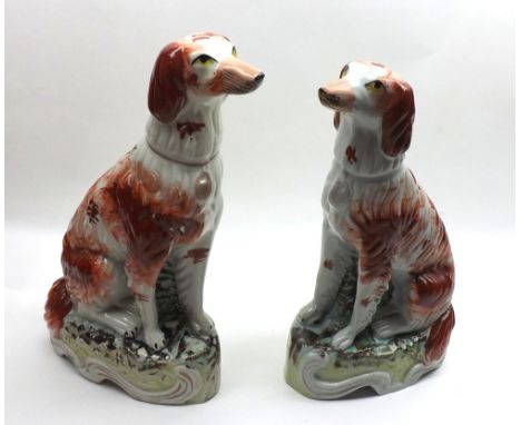 Pair of Staffordshire liver and white Spaniels, raised on oval plinth bases, 10 1/2" high&nbsp;
Condition:
Small paint losses