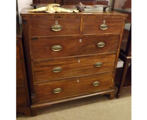 A 19th Century Mahogany Chest of two short and three long drawers, oval brass plate handles, reeded columns to sides, raised 