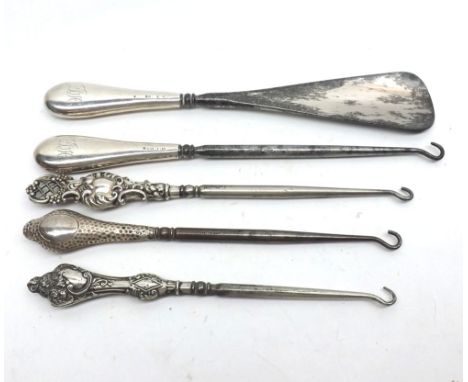 A Mixed Lot comprising: four assorted Hallmarked Silver-handled Button Hooks, the longest 9"; together with a Silver-handled 