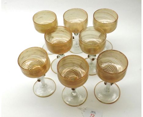 Set of eight Murano Glass pedestal drinking glasses, each with bowls decorated with a gilded swirl pattern, raised on short b