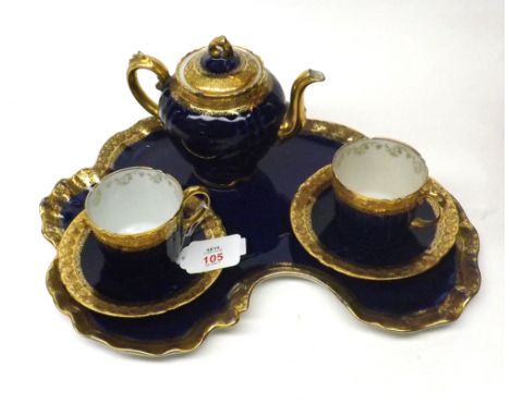 Late 19th Century Limoges gilt and blue decorated tea tray with two matching cups and saucers and accompanying matching tea p