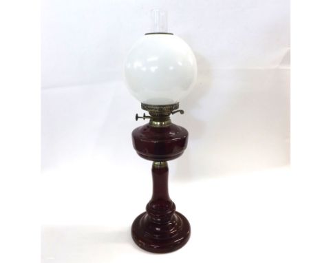20th Century Oil Lamp with clear glass chimney, opaque globe shade and a red glass body, 26 1/2" high&nbsp;
Condition:
Chippe
