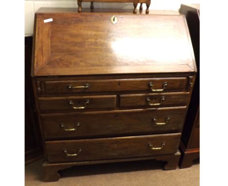 A Georgian Mahogany Bureau of typical form, the sloped front opening to an interior of small drawers, pigeonholes and central
