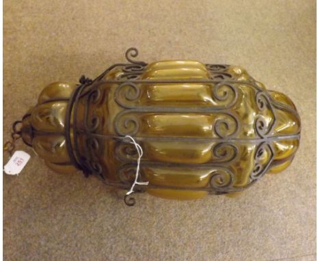 A Wrought Iron Framed and Yellow Glass Hall Hanging Light of moulded tapering circular form, 18" high  