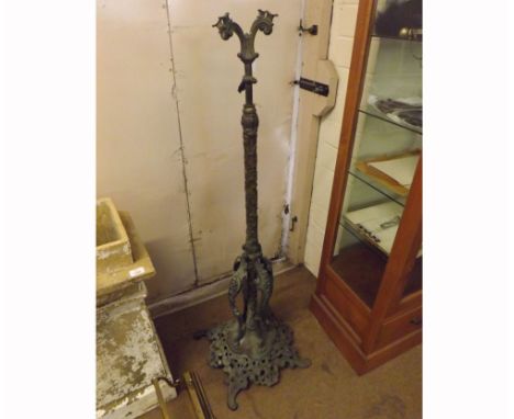 Large Victorian cast metal oil lamp stand of foliate form, the elaborate column over a pierced four-footed base with stylised