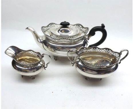 A good George V Three Piece Silver Tea Set, oval shaped with pierced and beaded wavy rims, each item supported on four curved