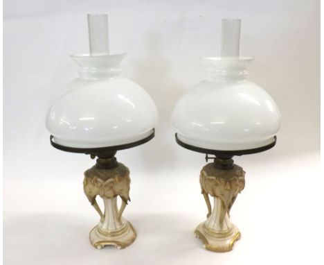Pair of unusual Continental Oil Lamps with clear glass chimneys, opaque glass shades and ceramic bodies formed as elephant's 