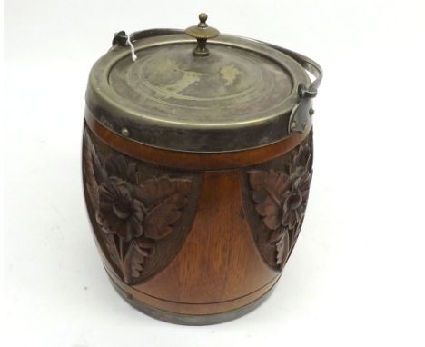An early 20th Century Carved Oak Biscuit Barrel with ceramic liner and silver plated fittings