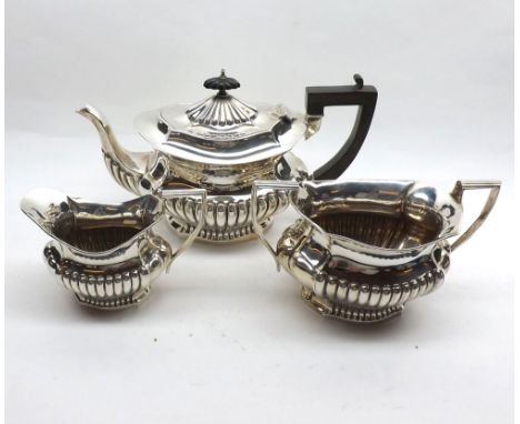 Early 20th Century three-piece Silver Tea Service, comprising a Tea Pot with swept hardwood handle, hinged lid with hardwood 