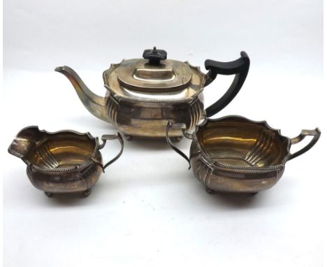 A George V Three Piece Silver Tea Set of shaped oval design, having gadrooned rims and fluted quarters, each item supported o