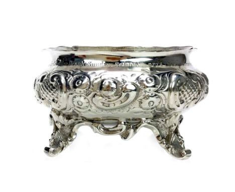 VICTORIAN SILVER CIRCULAR BOWL, maker JW&amp;JW, Edinburgh marks, embossed with scrolls and flora, inscription to rim, on fou