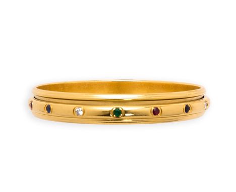 PIAGET: GEM-SET AND DIAMOND BANGLE accented with circular-cut emeralds, rubies, sapphires and brilliant-cut diamonds, signed 