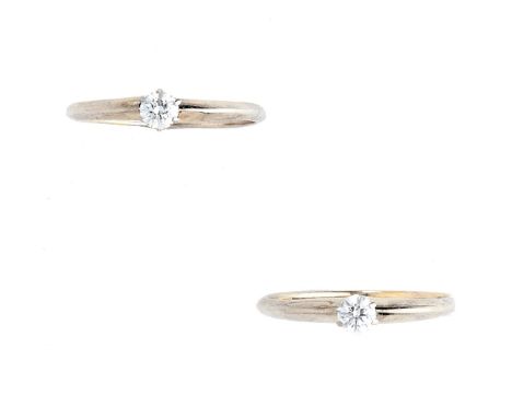 TWO DIAMOND RINGS each centring on a single brilliant-cut diamond, stamped Tiffany &amp; Co, ring size K 1/2, with two Tiffan