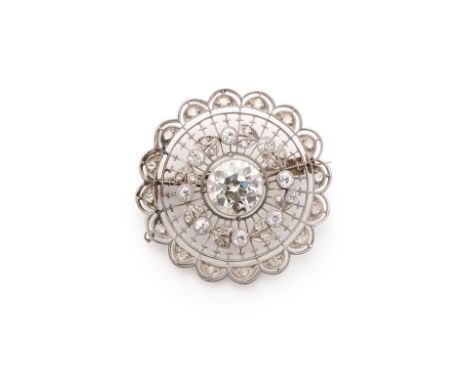 EDWARDIAN DIAMOND BROOCH, 1910s circular open work design, centring on a circular-cut diamond within a garland surround of ci