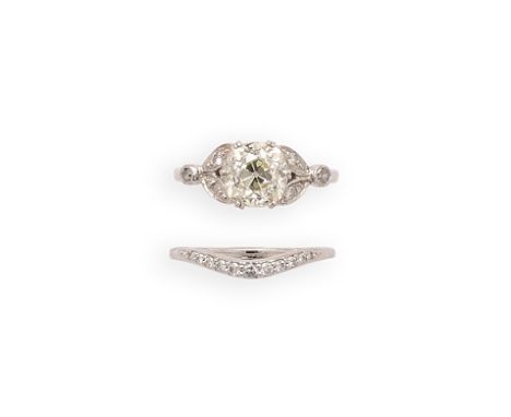 DIAMOND RING AND BAND RING claw set with a cushion-shaped diamond, to shoulders of leaf design accented with single-cut diamo