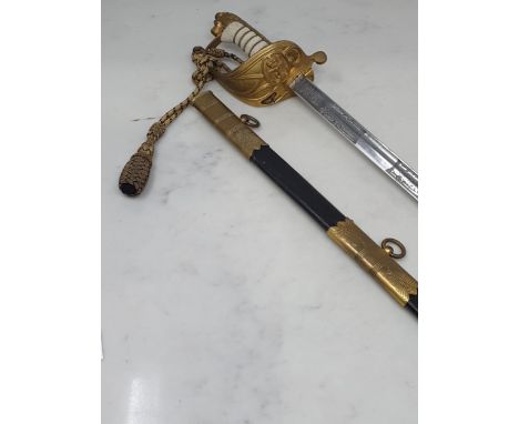 A British Naval Officer's Sword with shagreen grip and and engraved blade by Wilkinson Sword in leather and brass mounted sca